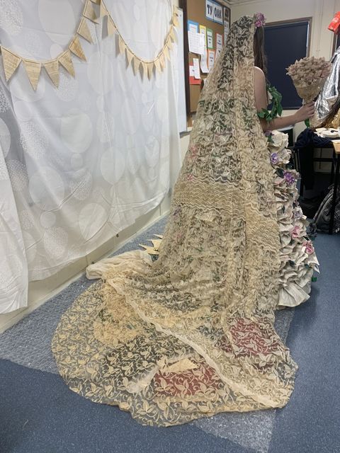 The dress is made out of pages from old books that were no longer being used