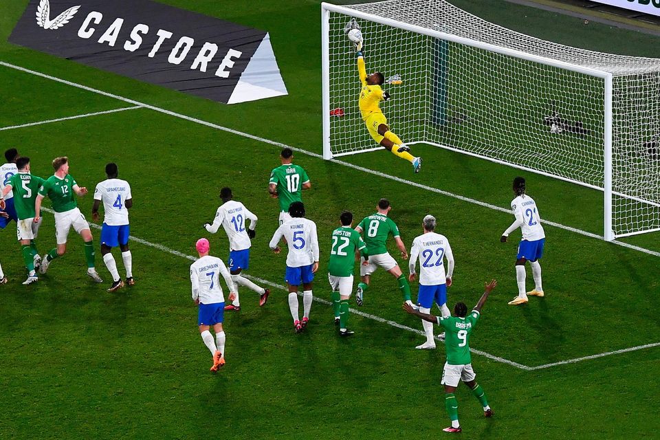 27 March 2023; France goalkeeper Mike Maignan saves the header from Nathan Collins of Republic of Ireland in the closing moments of the UEFA EURO 2024 Championship Qualifier match between Republic of Ireland and France at the Aviva Stadium in Dublin. Photo by Piaras Ó Mídheach/Sportsfile