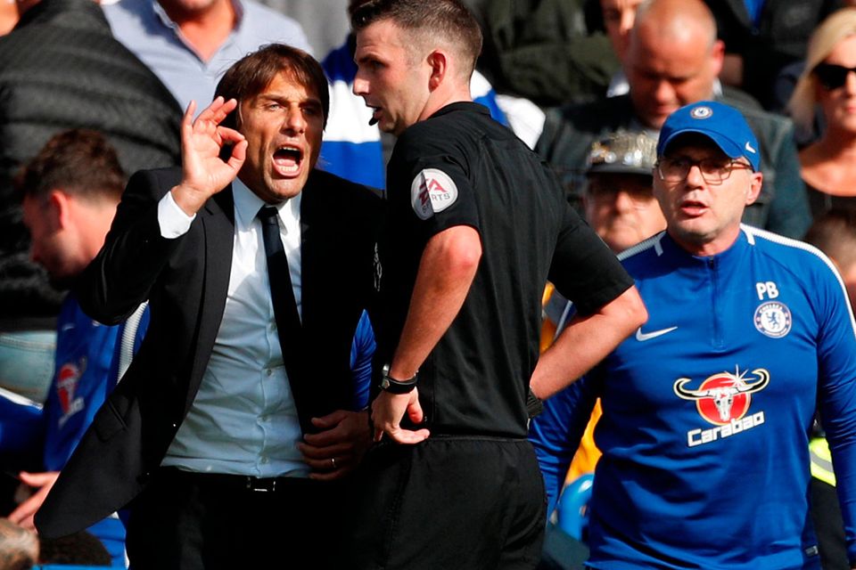 Chelsea manager Antonio Conte remonstrates with referee Michael Oliver after David Luiz was shown a red card