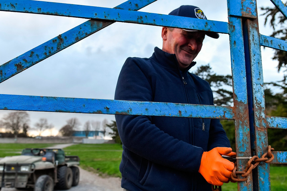 LOCKDOWN: Groundsman TJ Leahy locks the gates following racing at Clonmel Racecourse. Photo: Seb Daly/Sportsfile