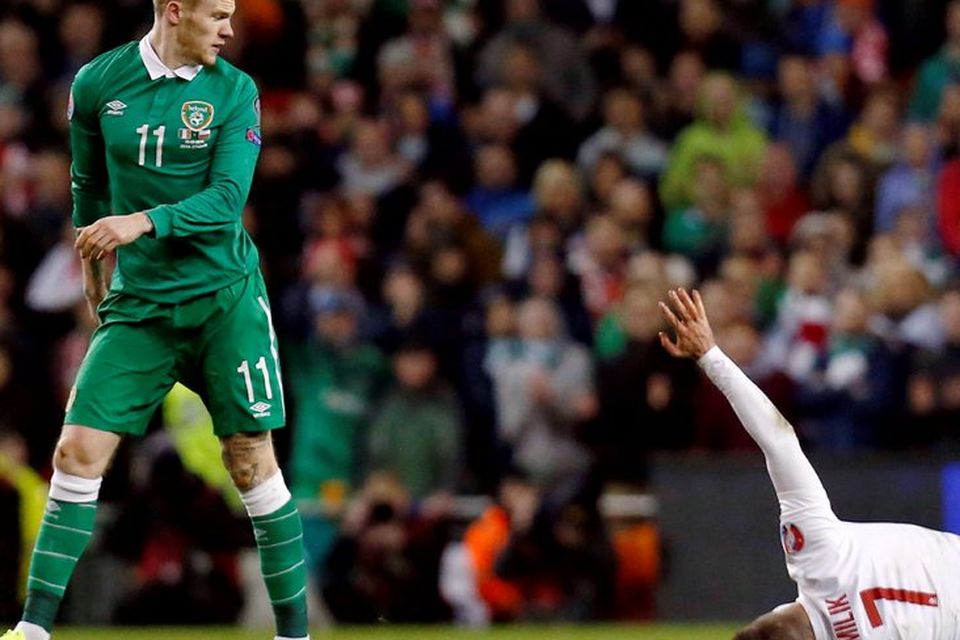 Ireland's James McClean looks towards Poland's Arkadiusk Milik as he lies on the pitch after his tough challenge
Reuters / Cathal McNaughton