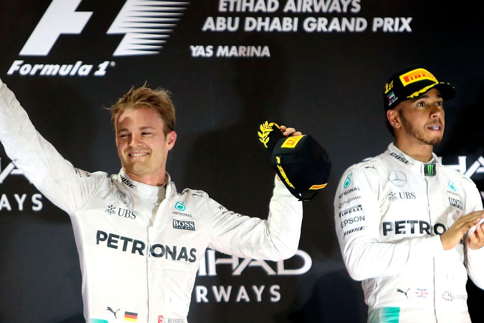 Nico Rosberg celebrates on the podium in Abu Dhabi after sealing the world championship as team-mate Lewis Hamilton applauds through gritted teeth. Photo: David Davies/PA