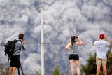 thumbnail: People watch as ash erupt from the Halemaumau crater near the community of Volcano during ongoing eruptions of the Kilauea Volcano in Hawaii, U.S., May 15, 2018.  REUTERS/Terray Sylvester