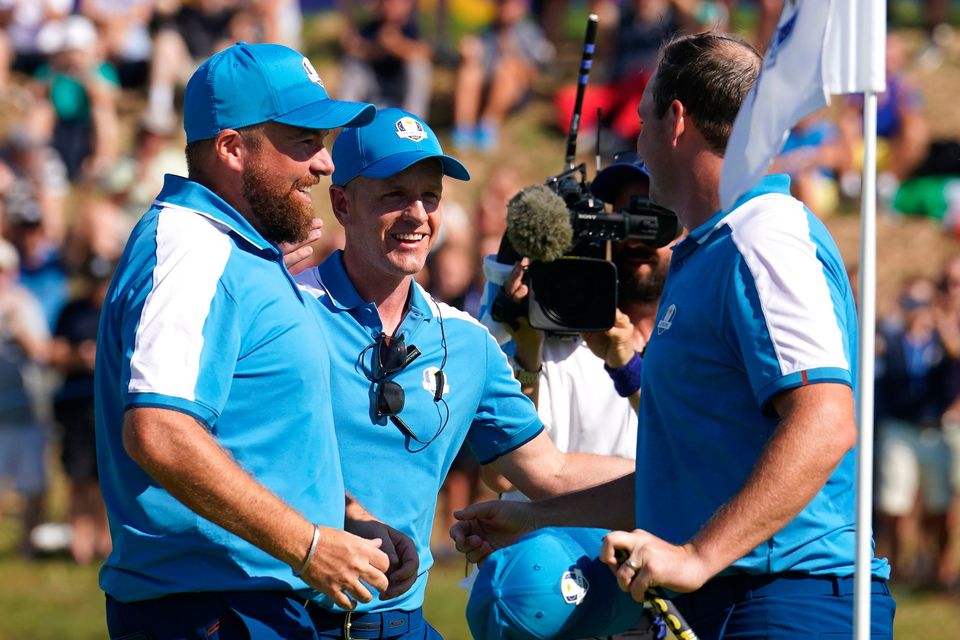 Team Europe's Shane Lowry and Sepp Straka celebrate winning their foursomes match with Team Europe Captain Luke Donald on day one of the 44th Ryder Cup at the Marco Simone Golf and Country Club, Rome