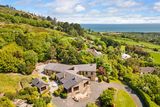 thumbnail: An aerial view of the house with the sea in the near distance