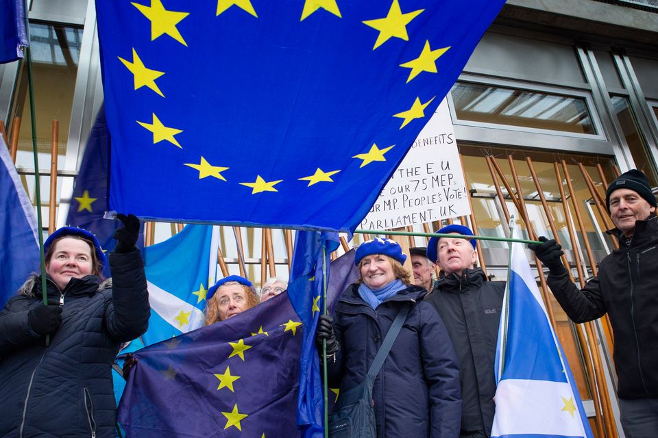 Pro-European protestors outside the Scottish Parliament, Edinburgh, as a vote is held against Theresa May's proposed Brexit deal with MSPs calling instead for a 'better alternative' to the PM's plans to be taken forward. Photo: Jane Barlow/PA Wire
