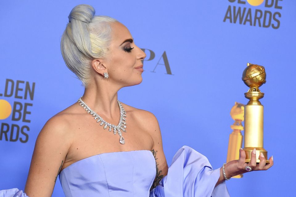 Lady Gaga pays tribute to Bradley Cooper as she picks up best song