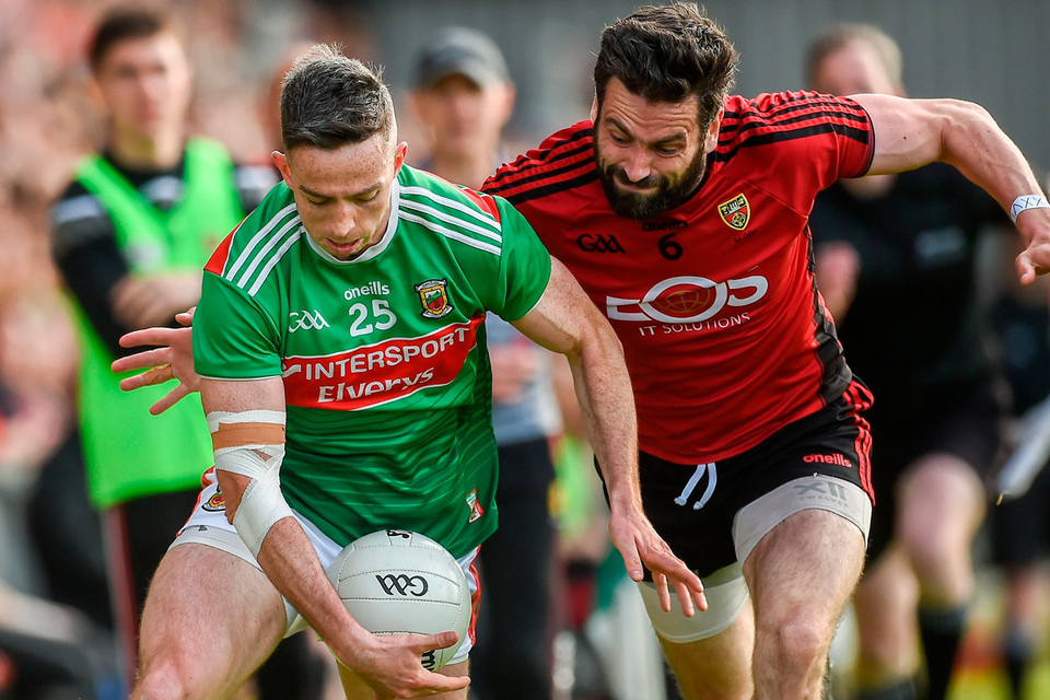 CLOSING IN: Mayo’s Evan Regan is challenged by Down’s Kevin McKernan during the All-Ireland SFC Round 2 qualifier at Páirc Esler in Newry, Down on Saturday.  Photo by Oliver McVeigh/Sportsfile