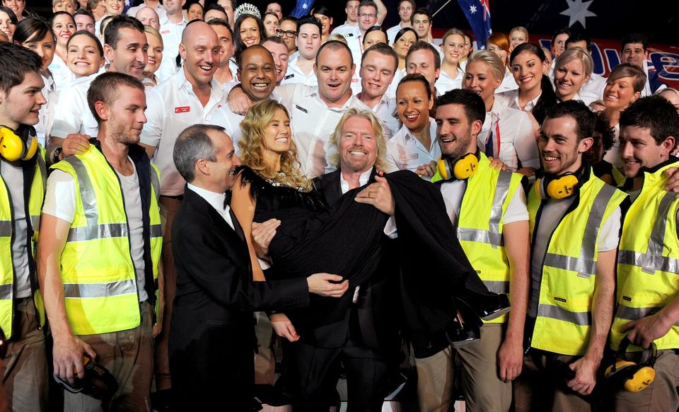 Virgin Blue's Sir Richard Branson (centre R) carries Australian singer Delta Goodrem (C) in 2010
