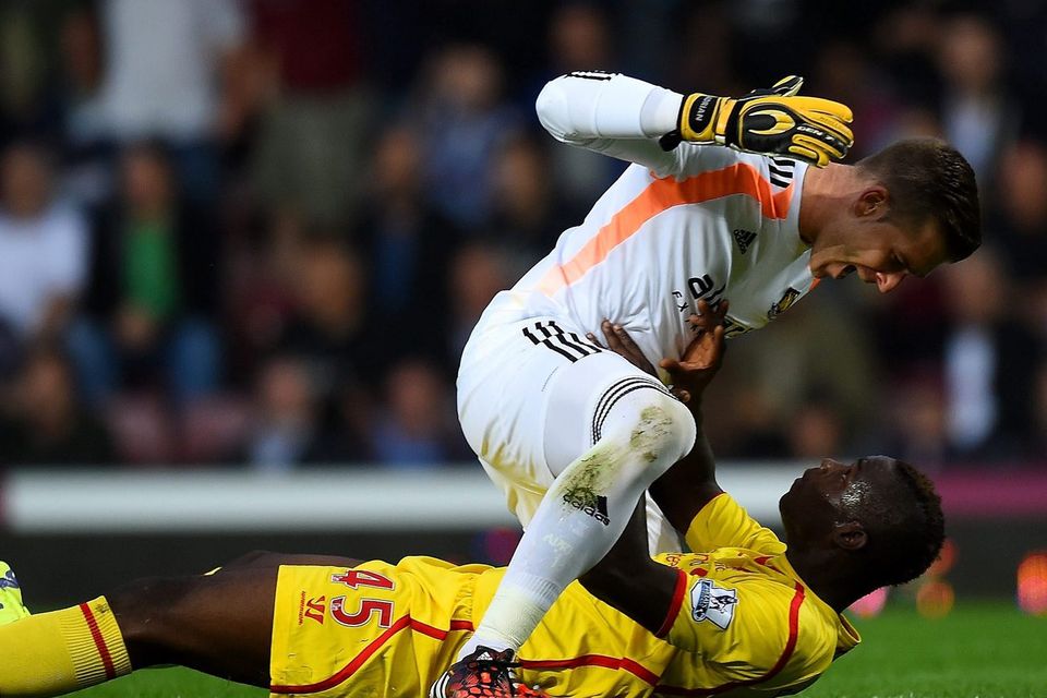 West Ham United goalkeeper Adrian clashes with Mario Balotelli during Liverpool's defeat at Upton Park. Photo: Mike Hewitt/Getty Images