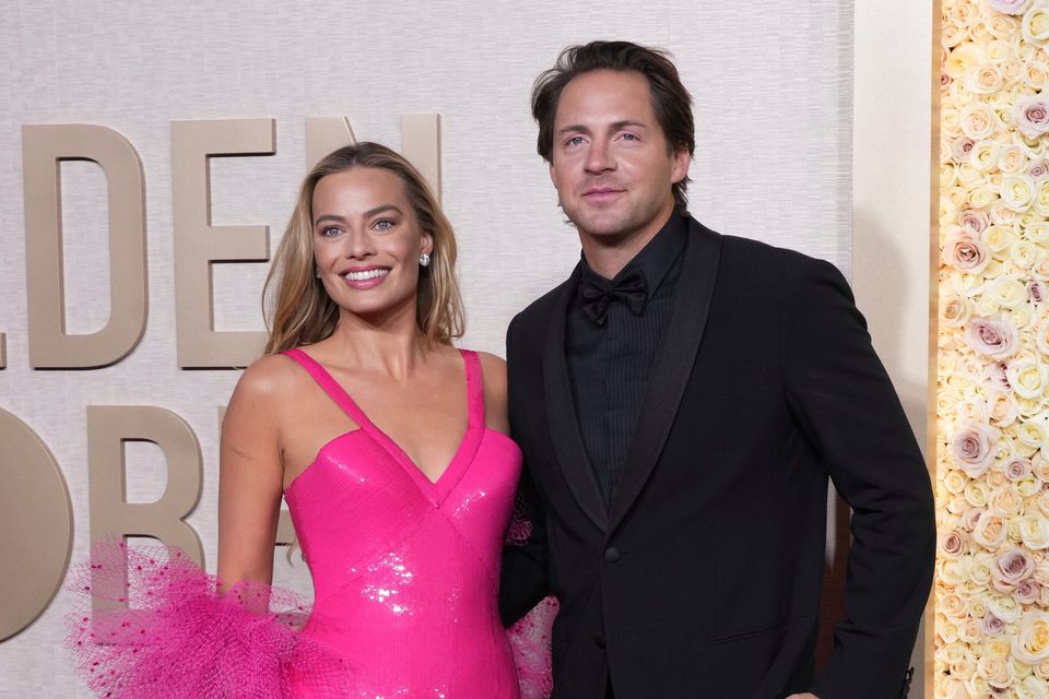 Margot Robbie, left, and Tom Ackerley arrive at the 81st Golden Globe Awards on Sunday, Jan. 7, 2024, at the Beverly Hilton in Beverly Hills, Calif. (Photo by Jordan Strauss/Invision/AP)