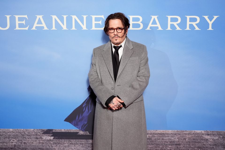 Johnny Depp wore a grey coat over a black suit to the premiere (Ian West/PA)