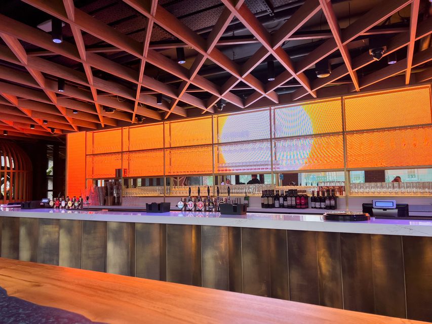 The hotel bar is backlit by LED screens