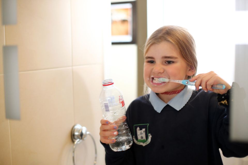 Problem: Emma Purcell (8), from north Co Dublin, is among the hundreds of thousands of people forced in recent weeks to use bottled water for everyday tasks such as brushing their teeth. Photo: Mark Condren