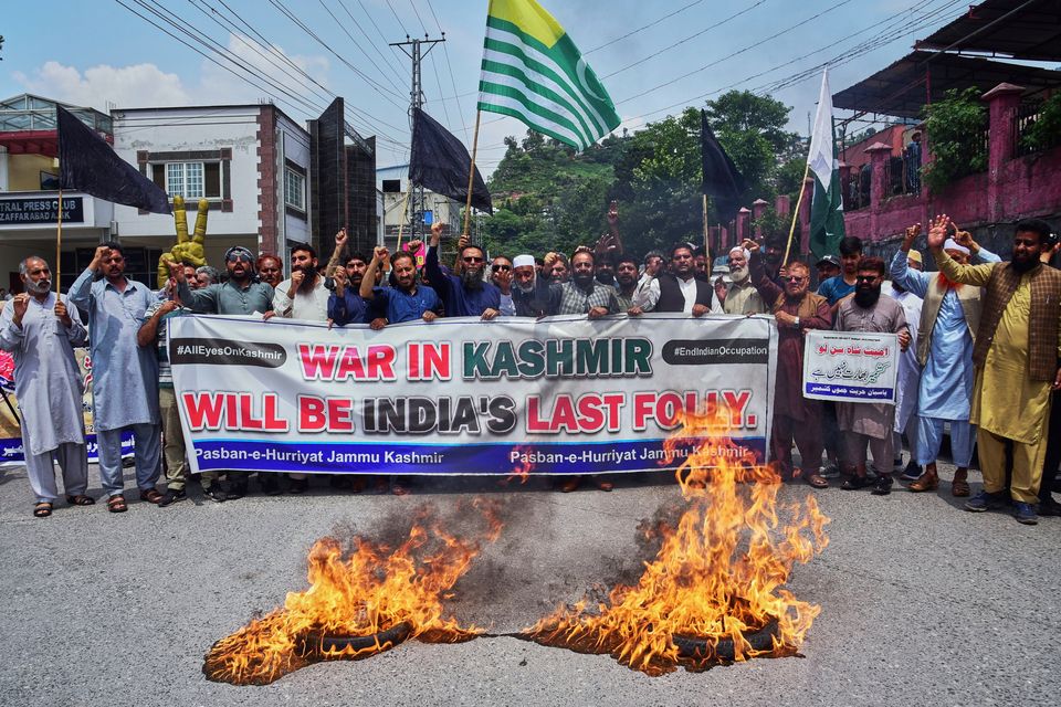 a

Supporters of Pasban-e-Hurriyat Jammu and Kashmir chant slogans next to burning tires during an anti-India demonstration, in Muzaffarabad, the capital of Pakistan:AP