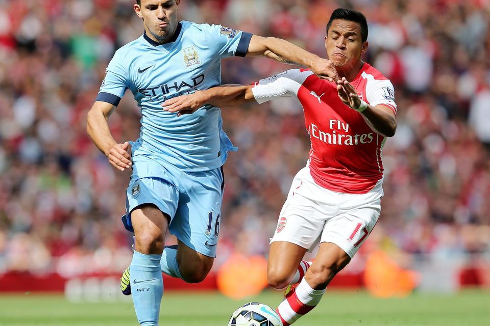 Manchester City's Sergio Aguero (left) is challenged by Arsenal's Alexis Sanchez