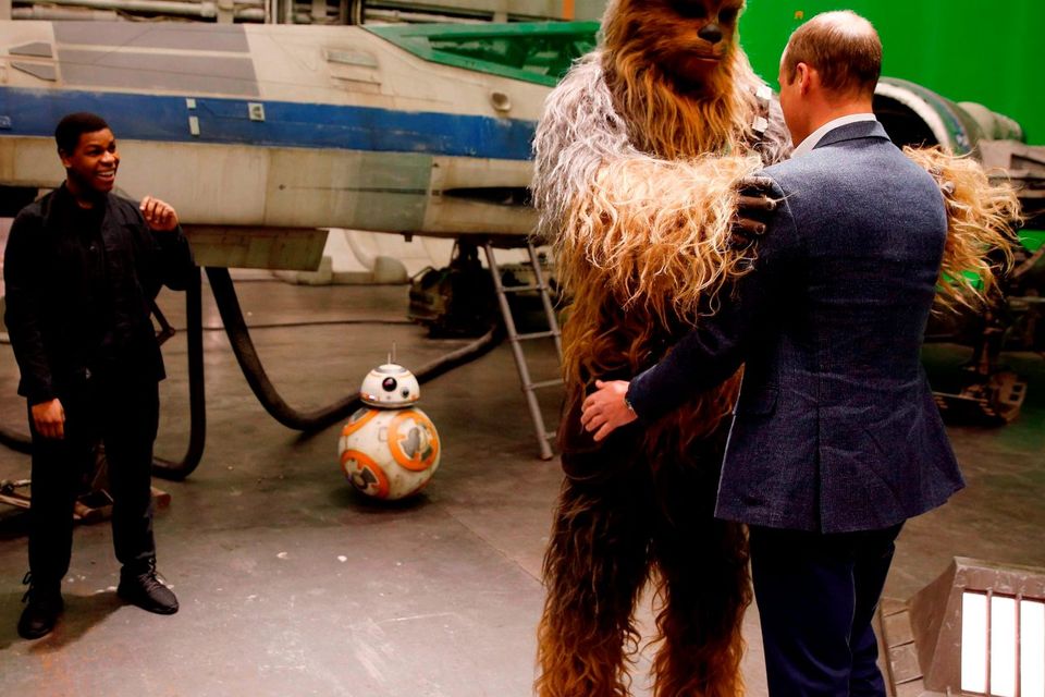 Britain's Prince William, Duke of Cambridge (R) is greeted by Chewbacca during a tour of the Star Wars sets at Pinewood studios in Iver Heath, west of London on April 19, 2016.AFP PHOTO / ADRIAN DENNISADRIAN DENNIS/AFP/Getty Images