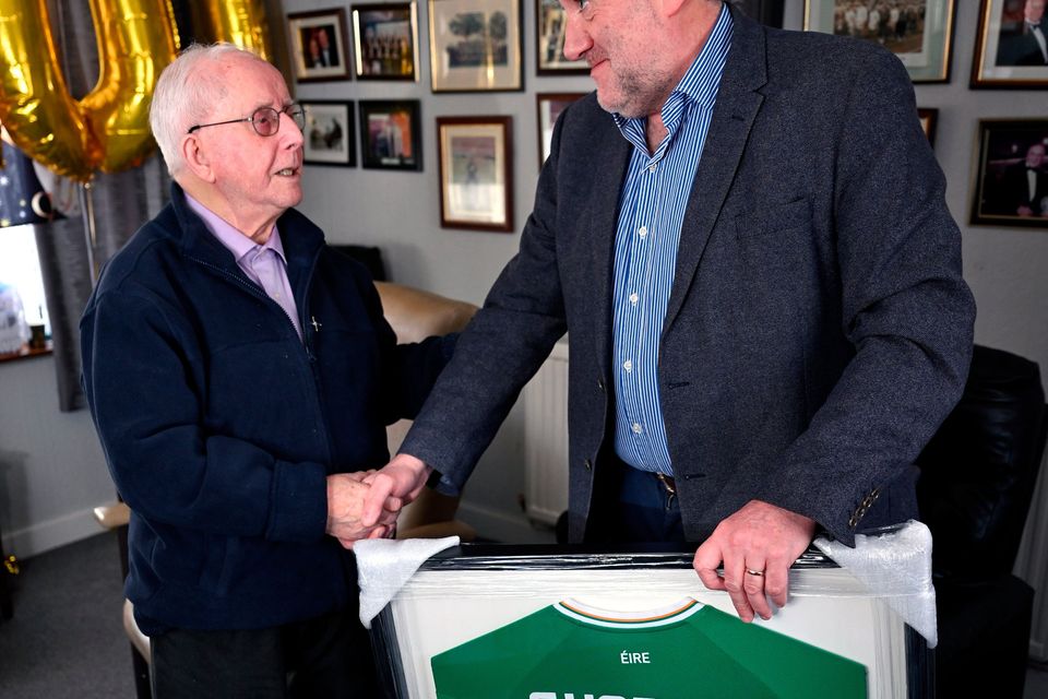 1 February 2024; FAI president Paul Cooke presents a specially commissioned Republic of Ireland jersey to former kit man, referee and legislator, Charlie O'Leary on the occasion of his 100th birthday. Photo by Ray McManus/Sportsfile 