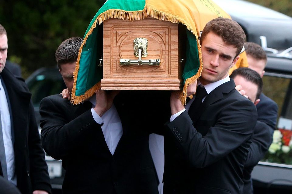 Grandson, Mikey Quinn, right, carries the coffin into St Marys Church, Killenaule, Co. Tipperary at the funeral of Billy Quinn