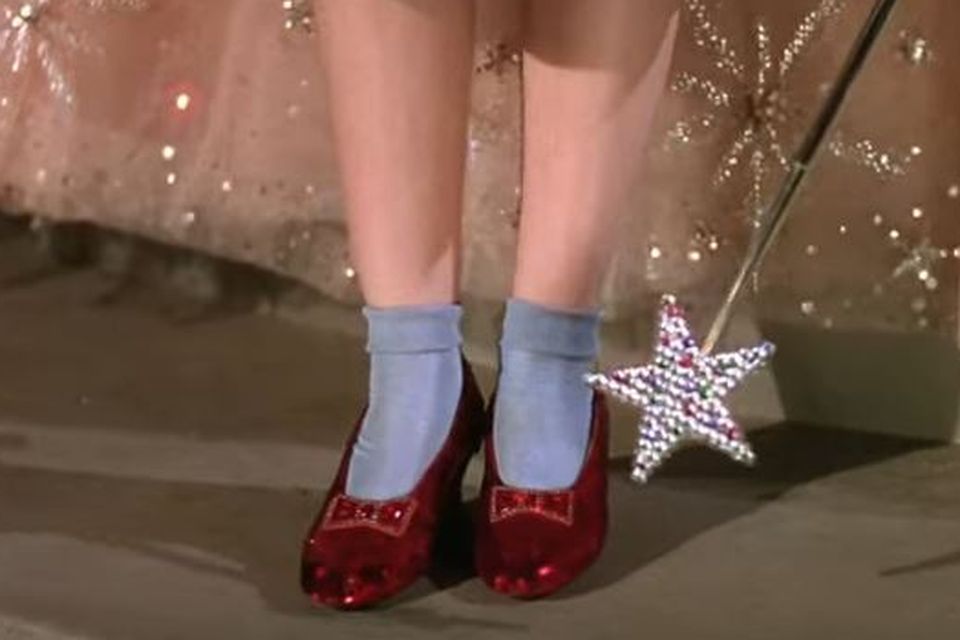 Judy Garland wearing the ruby slippers in The Wizard of Oz
