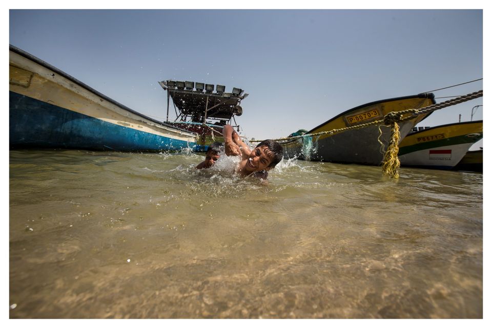 Boys swimming in Gaza port near where test rockets were fired earlier this week. Photo: Mark Condren