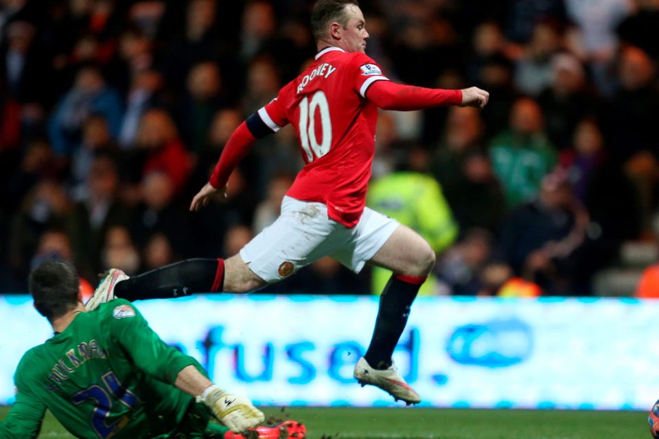Preston's Thorsten Stuckmann (L) concedes a penalty against Manchester United's Wayne Rooney