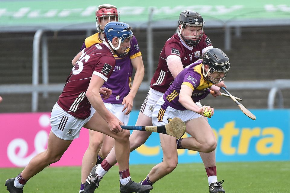 Wexford defender Cathal Sinnott under pressure as he tries to clear his lines. Photo: Jim Campbell