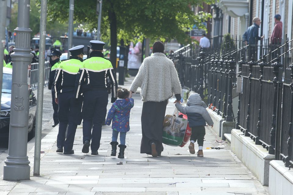 Asylum-seekers leaving Mount Street in Dublin accompanied by members of An Garda Síochána last Wednesday. Photo: Collins
