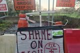 thumbnail: A sign erected by locals at the collapsed bridge at Wilton, Bree.