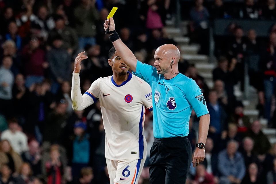 Chelsea goalkeeper Robert Sanchez (not pictured) is shown a yellow card by match referee Anthony Taylor (right) after fouling Bournemouth's Evanilson in the penalty box during the Premier League match at the Vitality Stadium. Photo credit: Andrew Matthews/PA Wire.