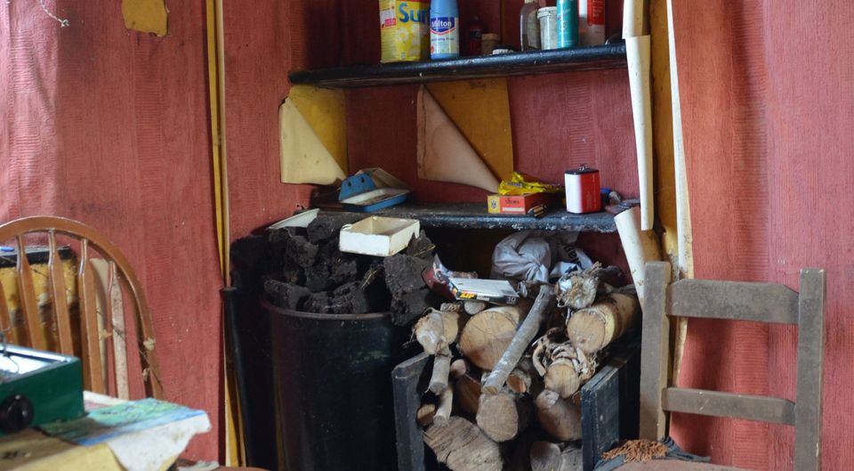 Provisions: Paddy's kitchen condiments shelf  is still filled, his turf and timber still stacked beside the fire; his hard fireside chair and the same calendar from 2006, the year his photo was taken for Vanishing Ireland