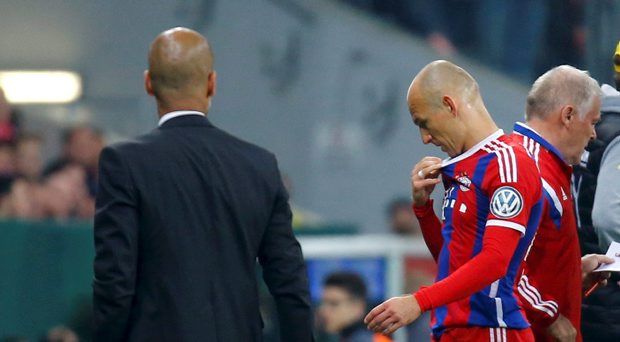 Bayern Munich's Arjen Robben walks past coach Pep Guardiola