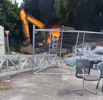 A digger destroyed by fire at the site in Coolock