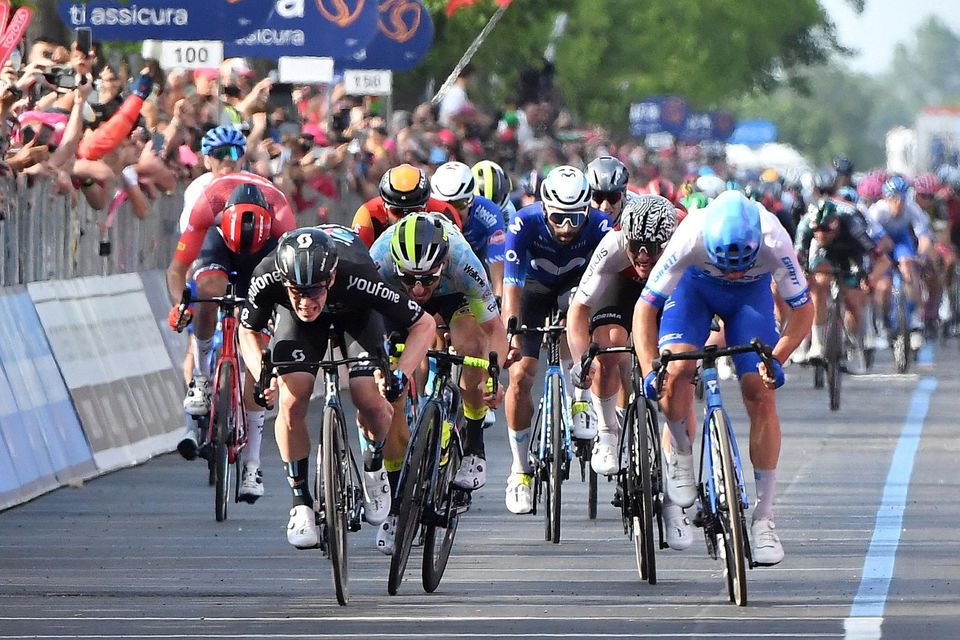 Team DSM's Alberto Dainese crosses the line to win stage 17 of the Giro d'Italia from Pergine Valsugana to Caorle