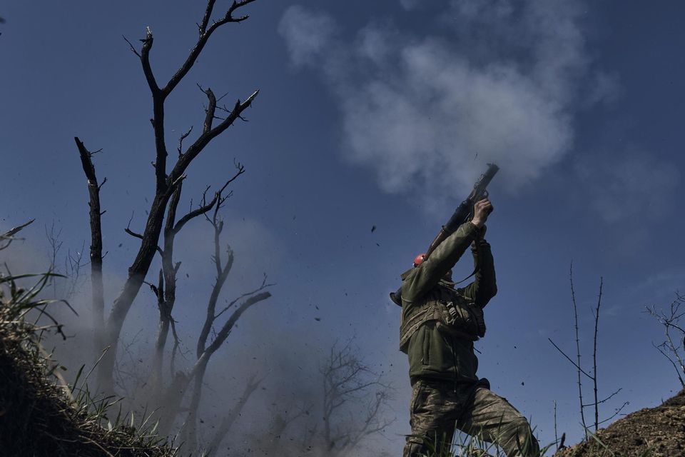 A Ukrainian soldier fires a grenade launcher on the frontline against Russia's invasion in Bakhmut. Photo: Libkos/AP