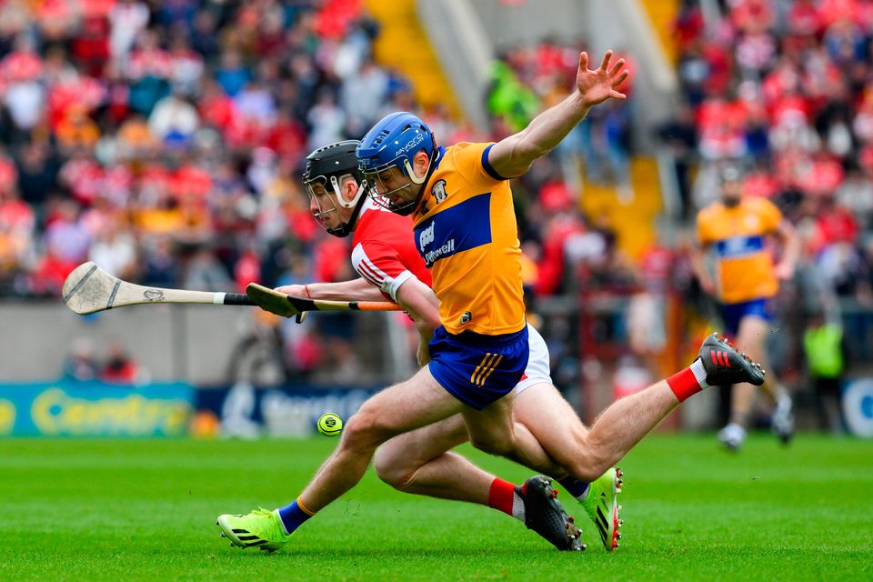Shane O'Donnell of Clare is tackled by Cork's Eoin Downey at Páirc Uí Chaoimh in Cork. Photo: Ray McManus/Sportsfile