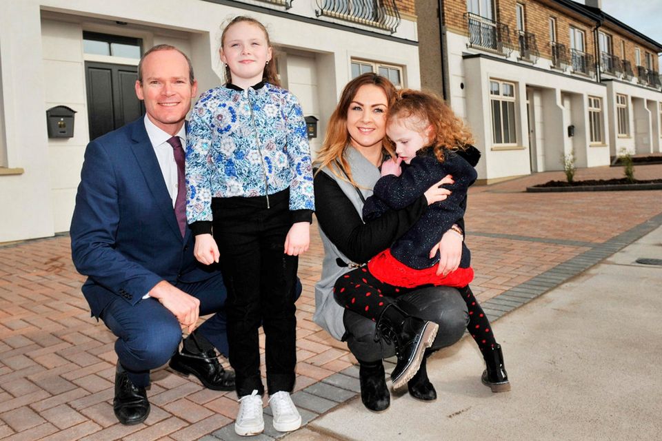 Housing Minister Simon Coveney with Jenna Foley and daughters Chloe (8) and Kaylee (5) as they show him their new home at Sheridan Park in Togher, Cork, yesterday. Jenna Foley has been on the housing waiting list for nine years. She will be the first resident of Sheridan Park later this week. Ms Foley said: 'It’s a dream come true – it’s a gorgeous house, but best of all it will be our home.' Photo: Daragh McSweeney