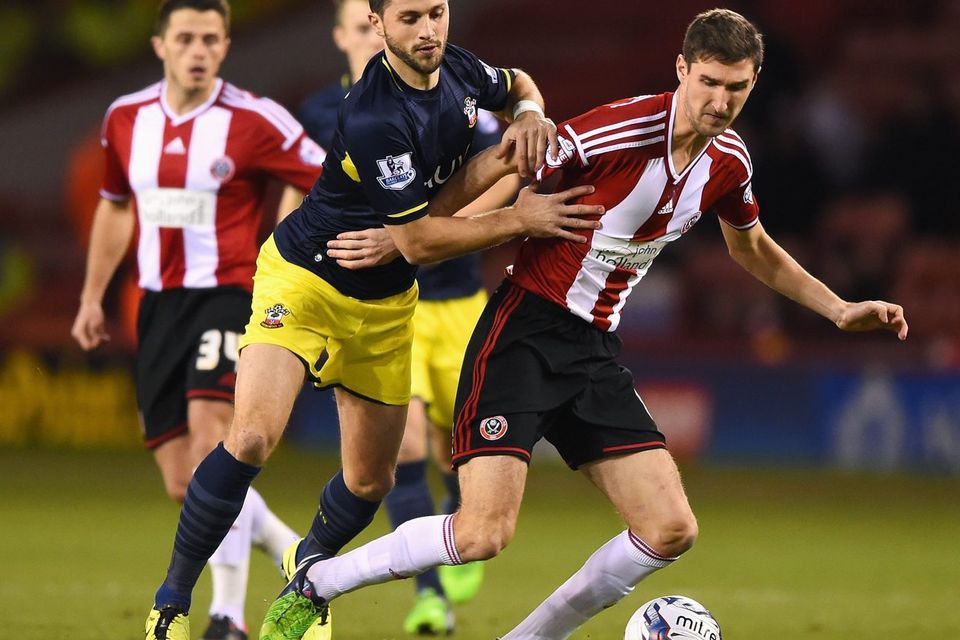 Southampton forward Shane Long challenges Sheffield United's Chris Basham during their Capital One Cup quarter-final clash at Bramall Lane. Photo: Shaun Botterill/Getty Images