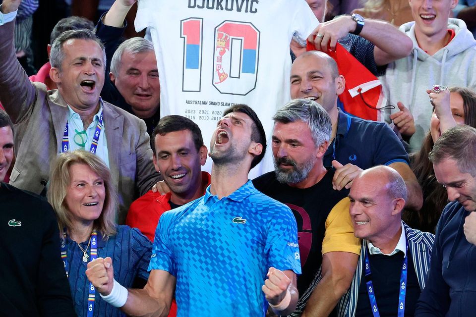 Novak Djokovic celebrates winning his 10th Australian Open with his family and coaching staff at Melbourne Park. Photo: Lintao Zhang/Getty Images