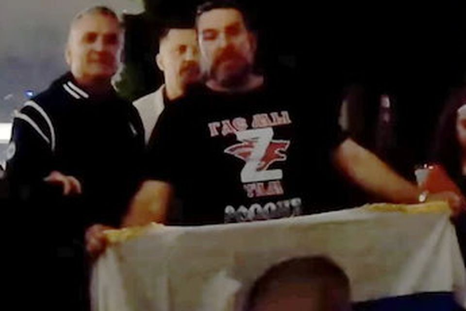 A still image from a video shows Srdjan Djokovic (left) posing with a fan holding a Russian flag with Vladimir Putin’s face on it and wearing a T-shirt with a ‘Z’, a symbol of the invasion of Ukraine. Photo: Twitter