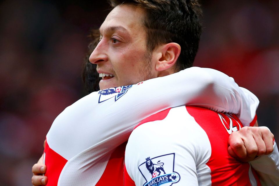 Arsenal's Mesut Ozil (R) celebrates his goal against Aston Villa with Santi Cazorla