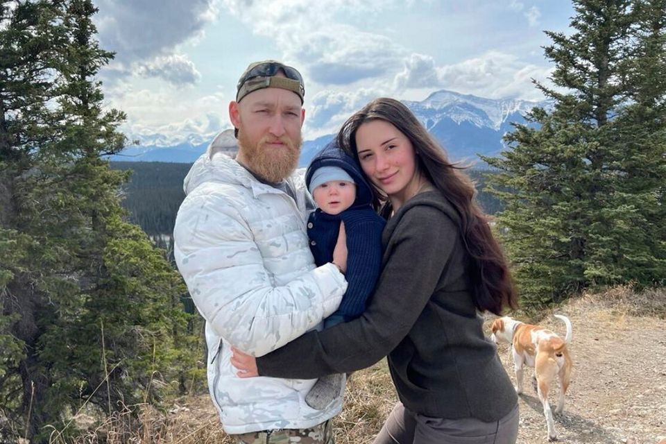 Air strike victim Jacob Flickinger, left, and Sandy Leclerc with their son Jasper