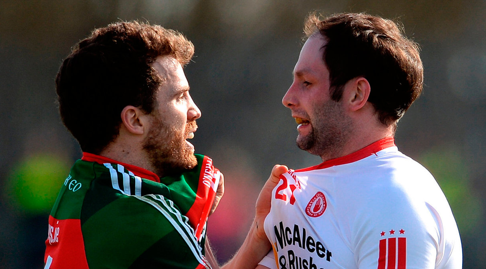 Chris Barrett of Mayo and Ronan McNabb get up close and personal. Photo:Oliver McVeigh/Sportsfile