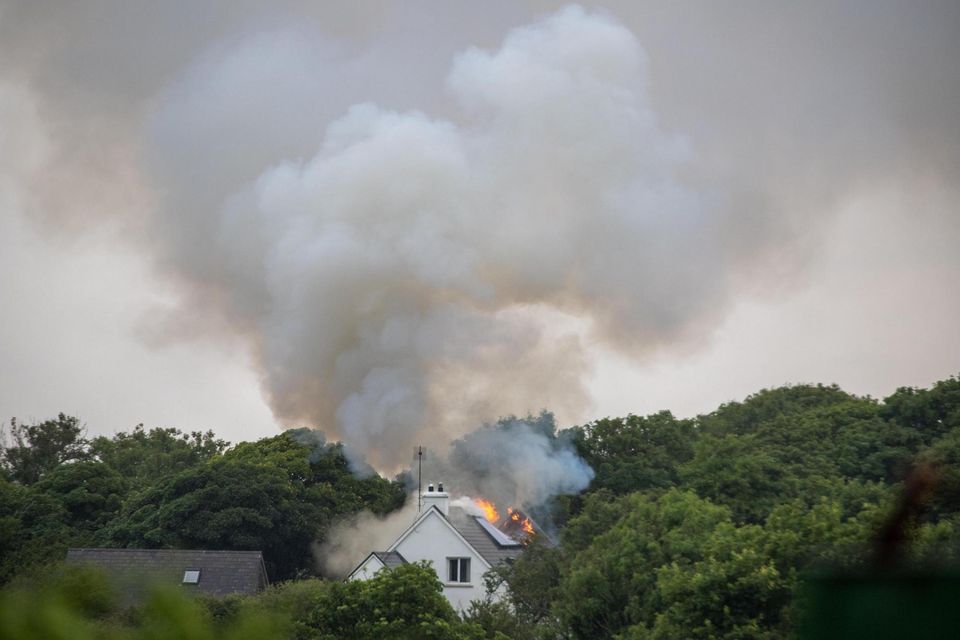 Fire crews attend to the scene of a house fire in North Clare this afternoon believed to have been started by a lightning strike (Photograph: Liam Burke, Press 22)