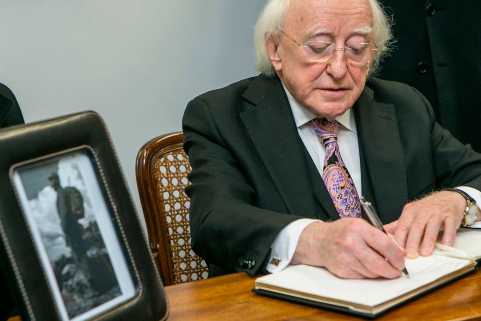 President Michael D Higgins and his wife Sabina signing the Book of Condolence for the late Fidel Castro at the Cuban Embassy on Pearse St Dublin. Photo: Kyran O'Brien