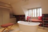 thumbnail: The en suite has a large inset cast iron bath.