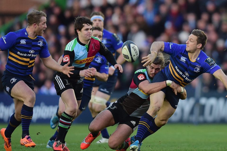 Leinster's Jimmy Gopperth offloads the ball off to Luke Fitzgerald after being tackled by Luke Wallace of Harlequins during their European Rugby Champions Cup clash at Twickenham Stoop. Photo: Jamie McDonald/Getty Images