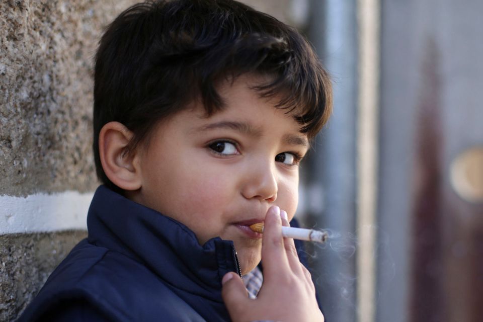 Fernando (6) smokes a cigarette in the village of Vale de Salgueiro, in northern Portugal. Photo: AP
