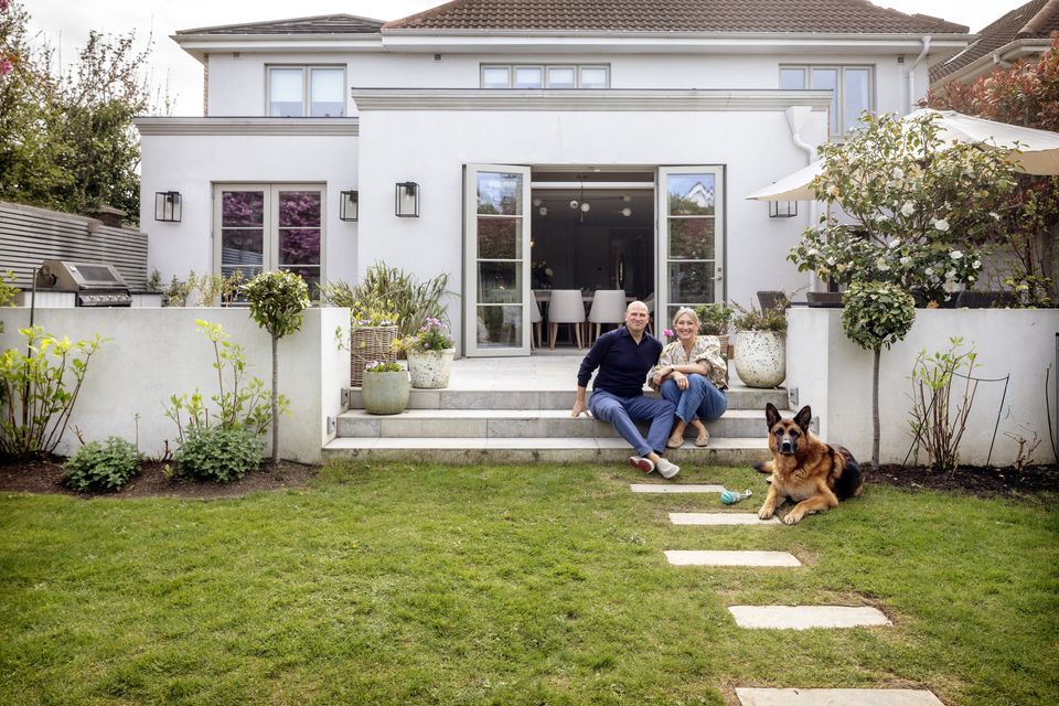 William and Aoife Diamond and their dog Senna outside their home in Castleknock, Co Dublin. They bought the house in the early noughties and extended recently with the help of Aoife’s sister, interior architect Eilish Rickard. The changes include an extension, the patio where they barbecue regularly and the ‘party palace’ in the garden. Photo: Tony Gavin