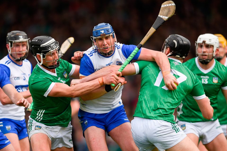 Darragh Lyons of Waterford is tackled by Gearóid Hegarty, left, and Conor Boylan of Limerick during the Munster SHC round five match at TUS Gaelic Grounds in Limerick. Photo: Tom Beary/Sportsfile
